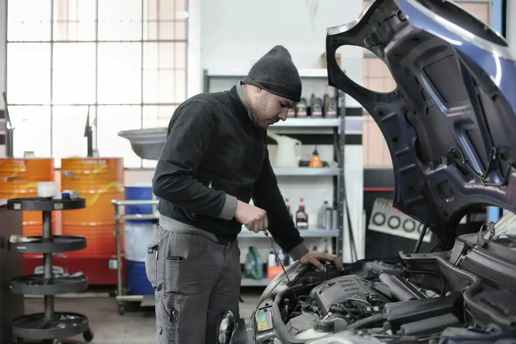 Technician checking oil at Krafte Tuning Rochdale